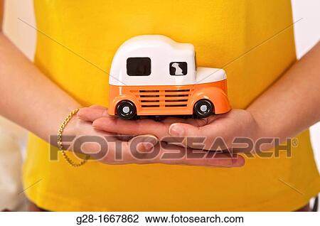Two woman's hands holding a toy car to symbolize driving or driving licence View Large Photo Image Stock Image - Two woman's hands holding a toy car to symbolize driving or driving licence. Fotosearch