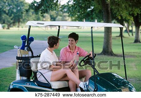 two women in their golf cart View Large Photo Image Stock Photo - two women in their golf cart. Fotosearch