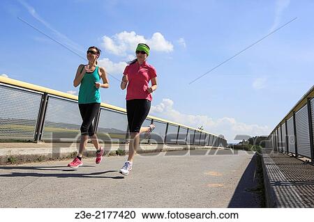 two women jogging over a bridge at the springtime. View Large Photo Image Stock Image - two women jogging over a bridge at the springtime.. Fotosearch
