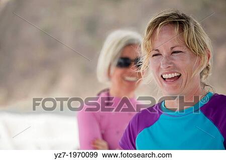 Two women laughing on tour boat off Isla Tortuga, Costa Rica View Large Photo Image Stock Photo - Two women laughing on tour boat off Isla Tortuga, Costa Rica. Fotosearch