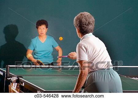 Two women over age 70 play ping pong at a seniors? athletic facility in the retirement community of Laguna Woods, CA. View Large Photo Image Stock Photo - Two women over age 70 play ping pong at a seniors? athletic facility in the retirement community of Laguna Woods, CA.. Fotosearch