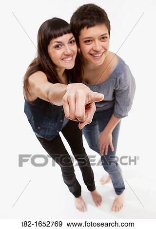 Two women pointing View Large Photo Image Stock Photo - Two women pointing. Fotosearch