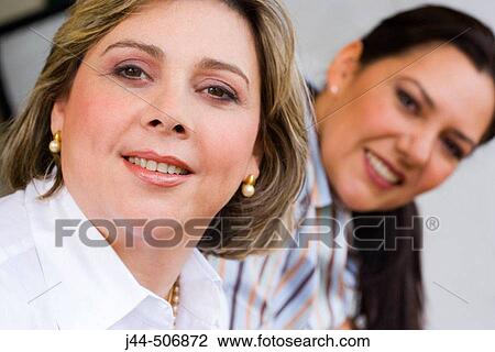 Stock Image - Two women portrait smiling. Fotosearch