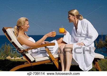 Two women relaxing in the sun View Large Photo Image Picture - Two women relaxing in the sun. Fotosearch