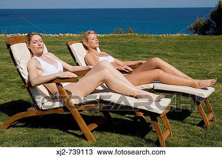 Two women relaxing in the sun View Large Photo Image Stock Image - Two women relaxing in the sun. Fotosearch