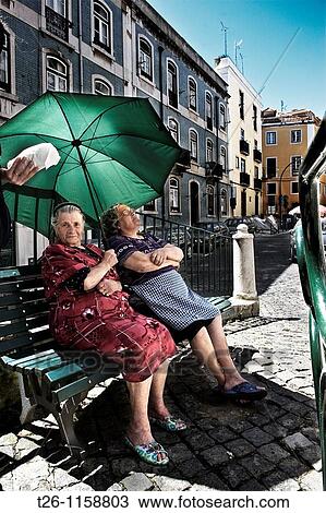 two women sitting in the shade in the Alfama district. Lisbon, Portugal View Large Photo Image Stock Image - two women sitting in the shade in the Alfama district. Lisbon, Portugal. Fotosearch