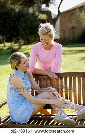 Stock Image - Two women talking outdoors. Fotosearch
