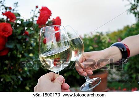 Two women toasting with wine glasses View Large Photo Image Stock Image - Two women toasting with wine glasses. Fotosearch