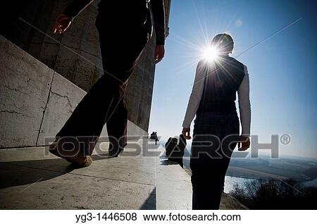 Stock Photo - Two women walking along steps of Walhalla temple with Danube river in background, Regensburg, Germany. Fotosearch