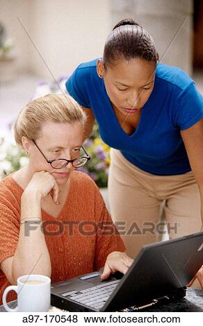 Two women working View Large Photo Image Stock Photo - Two women working. Fotosearch