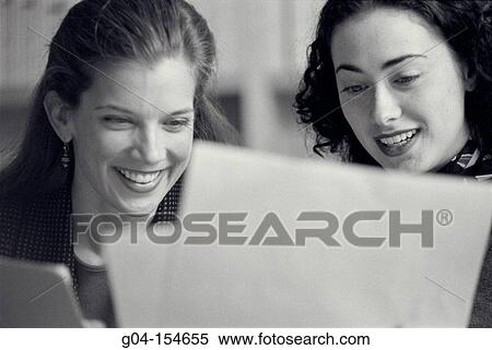 Two women working View Large Photo Image Stock Photography - Two women working. Fotosearch