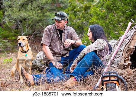 Two woodworkers and their dog are taking a break in a forest, chainsaw and ax next to them, Male Caucasian, 40 years, Female Caucasian, 18 years, Texas, USA View Large Photo Image Stock Image - Two woodworkers and their dog are taking a break in a forest, chainsaw and ax next to them, Male Caucasian, 40 years, Female Caucasian, 18 years, Texas, USA. Fotosearch