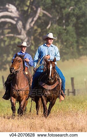 Two wranglers (cowboys) on horses, California, USA View Large Photo Image Stock Photo - Two wranglers (cowboys) on horses, California, USA. Fotosearch