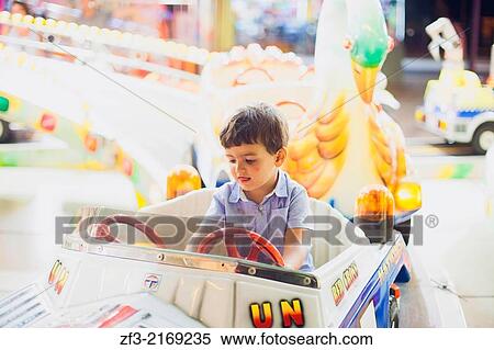 Two year old boy in a amusement park car. View Large Photo Image Stock Photography - Two year old boy in a amusement park car.. Fotosearch