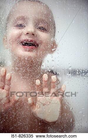 Stock Photography - Two year old boy playing during his bath. Fotosearch