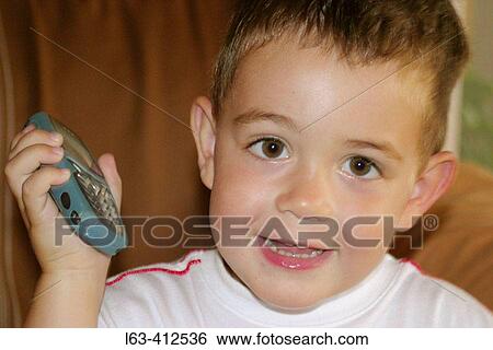 Two year old boy with mobile phone View Large Photo Image Stock Photograph - Two year old boy with mobile phone. Fotosearch