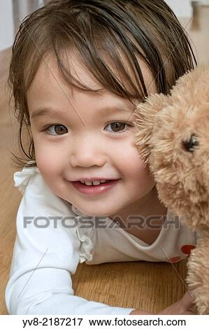 Two year old girl with her teddy bear. View Large Photo Image Stock Photo - Two year old girl with her teddy bear.. Fotosearch