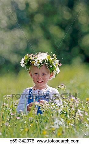 Two year old girl with wreath made of flowers in direct light. V? sterbotten, Sweden View Large Photo Image Stock Photograph - Two year old girl with wreath made of flowers in direct light. V? sterbotten, Sweden. Fotosearch