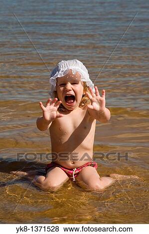 Two Years Old Baby Girl Sitting in Water and Making Stop Gesture with Refusing Hands Up View Large Photo Image Stock Photo - Two Years Old Baby Girl Sitting in Water and Making Stop Gesture with Refusing Hands Up. Fotosearch