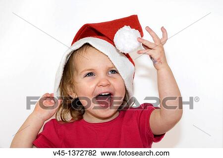 Two years old girl playing with Santa hat. View Large Photo Image Stock Image - Two years old girl playing with Santa hat.. Fotosearch