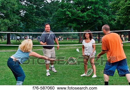 Two young ( 20? s) couples playing badminton. View Large Photo Image Stock Image - Two young ( 20? s) couples playing badminton.. Fotosearch