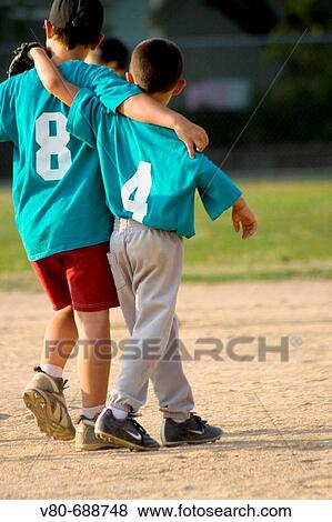 Two young boys age 7 walking on field in friendship with arms around shoulders Groveland School Field St Paul Minnesota USA View Large Photo Image Stock Photo - Two young boys age 7 walking on field in friendship with arms around shoulders Groveland School Field St Paul Minnesota USA. Fotosearch