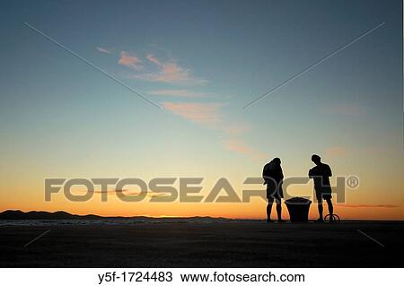 Two young boys at the end of a beach day View Large Photo Image Stock Image - Two young boys at the end of a beach day. Fotosearch