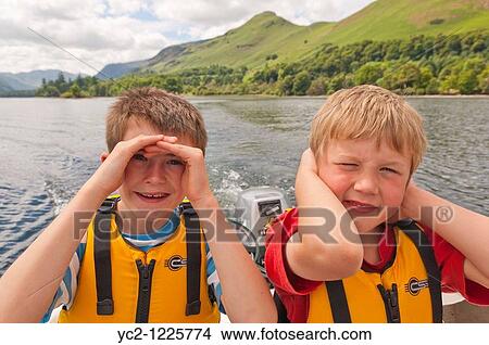 Picture - Two young boys in hire boat at Derwent water at Keswick, Lake District National Park, Cumbria, England, Great Britain, Uk. Fotosearch