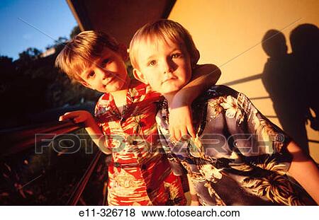 Two young brothers outdoors View Large Photo Image Stock Photo - Two young brothers outdoors. Fotosearch