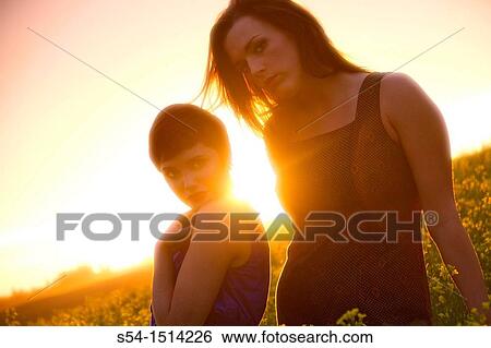 Two young caucasian women in a canola field near Spokane, Washington, USA. View Large Photo Image Stock Photograph - Two young caucasian women in a canola field near Spokane, Washington, USA.. Fotosearch