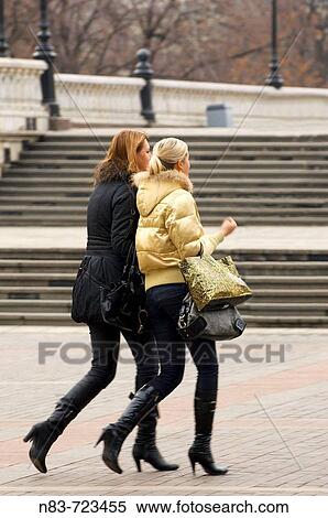 Two young fashionable Moscovite women walk perfectly in step at Manezhnaya Square, Moscow, Russian Federation View Large Photo Image Stock Photography - Two young fashionable Moscovite women walk perfectly in step at Manezhnaya Square, Moscow, Russian Federation. Fotosearch