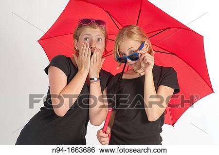 Stock Photograph - Two young German girls under an umbrella.. Fotosearch