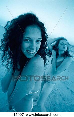 Two young girls on a beach View Large Photo Image Stock Photo - Two young girls on a beach. Fotosearch