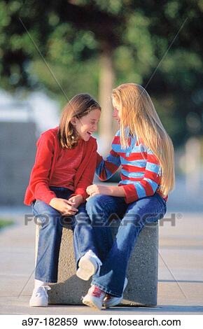 Two young girls outdoors laughing View Large Photo Image Stock Photo - Two young girls outdoors laughing. Fotosearch