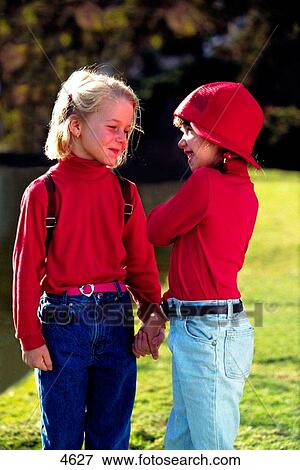 Two young girls talking View Large Photo Image Stock Photo - Two young girls talking. Fotosearch