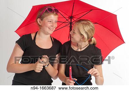 Two young girls under an umbrella German. View Large Photo Image Stock Photo - Two young girls under an umbrella German.. Fotosearch