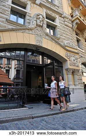 two young girls walking in front of the facade of the Art Nouveau building housing the Neiburgs hotel, Riga, Latvia, Baltic region, Northern Europe View Large Photo Image Stock Image - two young girls walking in front of the facade of the Art Nouveau building housing the Neiburgs hotel, Riga, Latvia, Baltic region, Northern Europe. Fotosearch