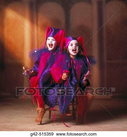 Stock Photo - Two young girls wearing jester costumes.. Fotosearch
