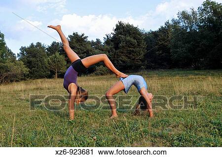 two young gymnasts doing gymnastics in a meadow in the Pyrenees View Large Photo Image Stock Image - two young gymnasts doing gymnastics in a meadow in the Pyrenees. Fotosearch