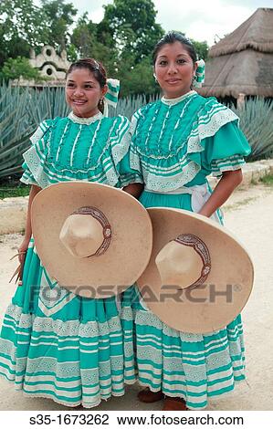 Two young ladies dressed in traditional Mexican skirt and carrying straw Sombrero hat posing for camera Cancun Mexico. View Large Photo Image Stock Image - Two young ladies dressed in traditional Mexican skirt and carrying straw Sombrero hat posing for camera Cancun Mexico.. Fotosearch