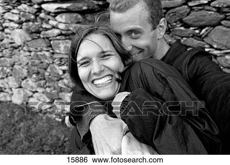 Two young lovers shoot a self portrait in an ancient stone circle with stone wall behind near Clogheen, Ireland View Large Photo Image Stock Photograph - Two young lovers shoot a self portrait in an ancient stone circle with stone wall behind near Clogheen, Ireland. Fotosearch