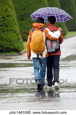two young man walking togher with umbrella, couple, rain, homosexualism, Geneva, Switzerland View Large Photo Image Stock Image - two young man walking togher with umbrella, couple, rain, homosexualism, Geneva, Switzerland. Fotosearch