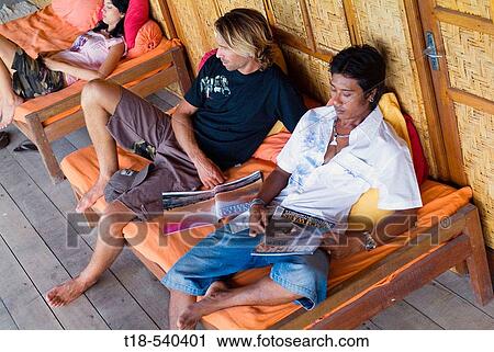 two young men and woman relaxing on bench View Large Photo Image Stock Image - two young men and woman relaxing on bench. Fotosearch