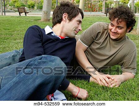 Two young men looking at each other View Large Photo Image Stock Photo - Two young men looking at each other. Fotosearch