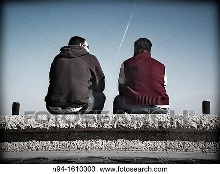 Two young men sitting drinking beer paths. View Large Photo Image Stock Image - Two young men sitting drinking beer paths.. Fotosearch