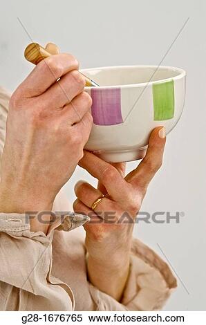 Two young woman? shands holding a spoon and stirring a liquid in a bowl View Large Photo Image Stock Photography - Two young woman? shands holding a spoon and stirring a liquid in a bowl. Fotosearch