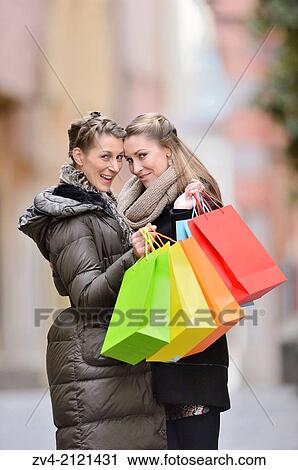 Two young woman with their bags from a shopping tour in a city in Germany. View Large Photo Image Stock Image - Two young woman with their bags from a shopping tour in a city in Germany.. Fotosearch