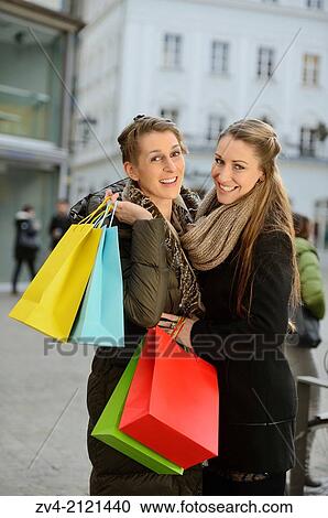 Two young woman with their bags from a shopping tour in a city in Germany. View Large Photo Image Stock Image - Two young woman with their bags from a shopping tour in a city in Germany.. Fotosearch
