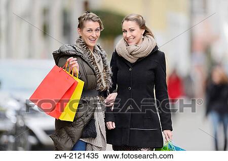 Two young woman with their bags from a shopping tour in a city in Germany. View Large Photo Image Stock Photography - Two young woman with their bags from a shopping tour in a city in Germany.. Fotosearch