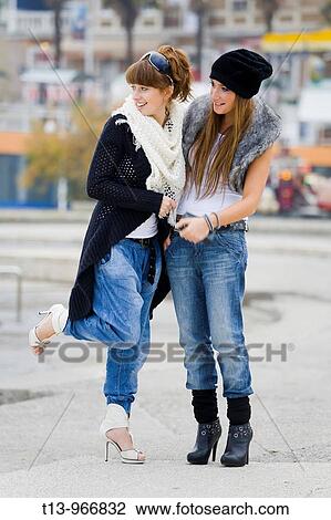 Stock Image - Two young women are expecting someone. Fotosearch